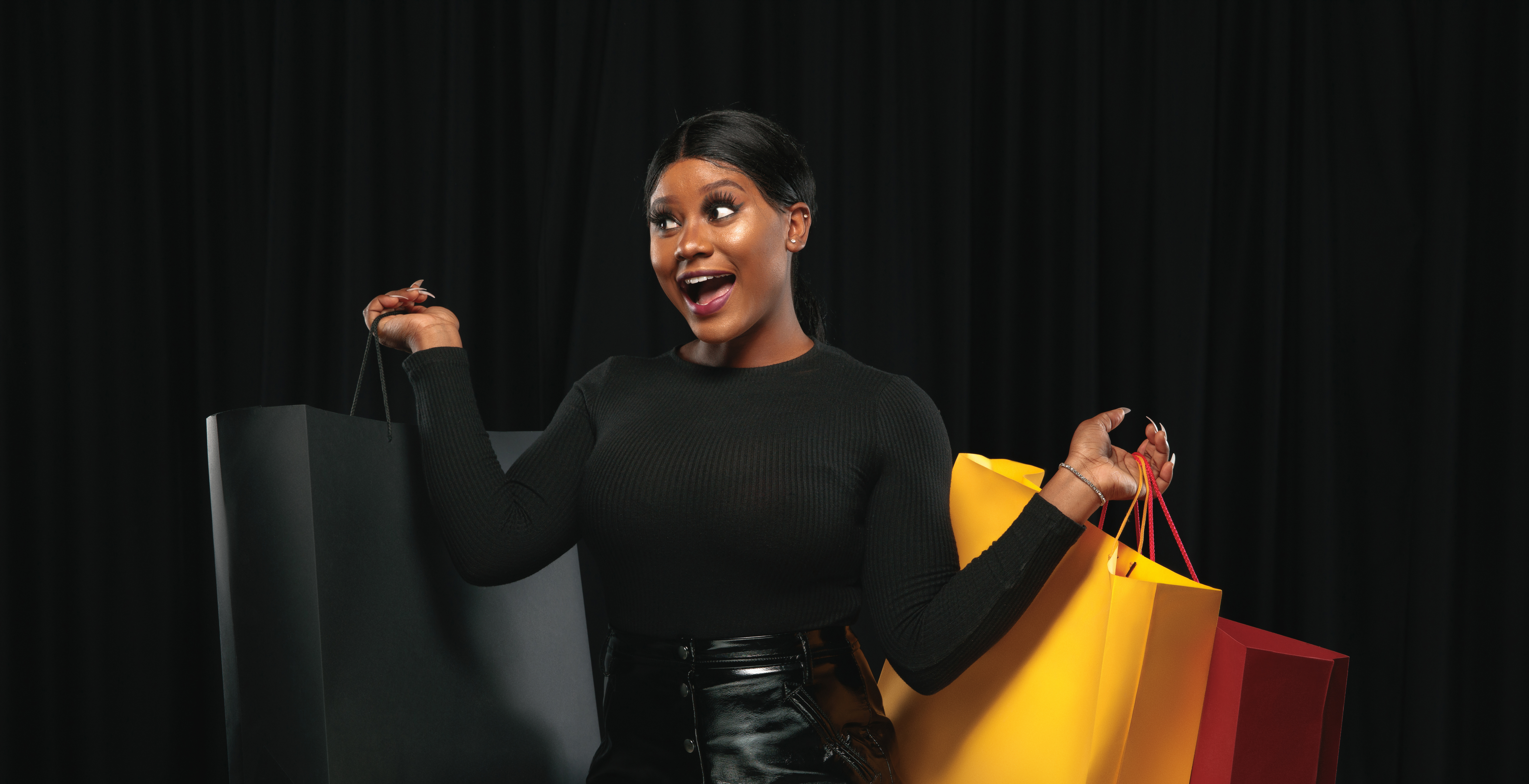 Woman smiling in happyness with shopping bags in her hands